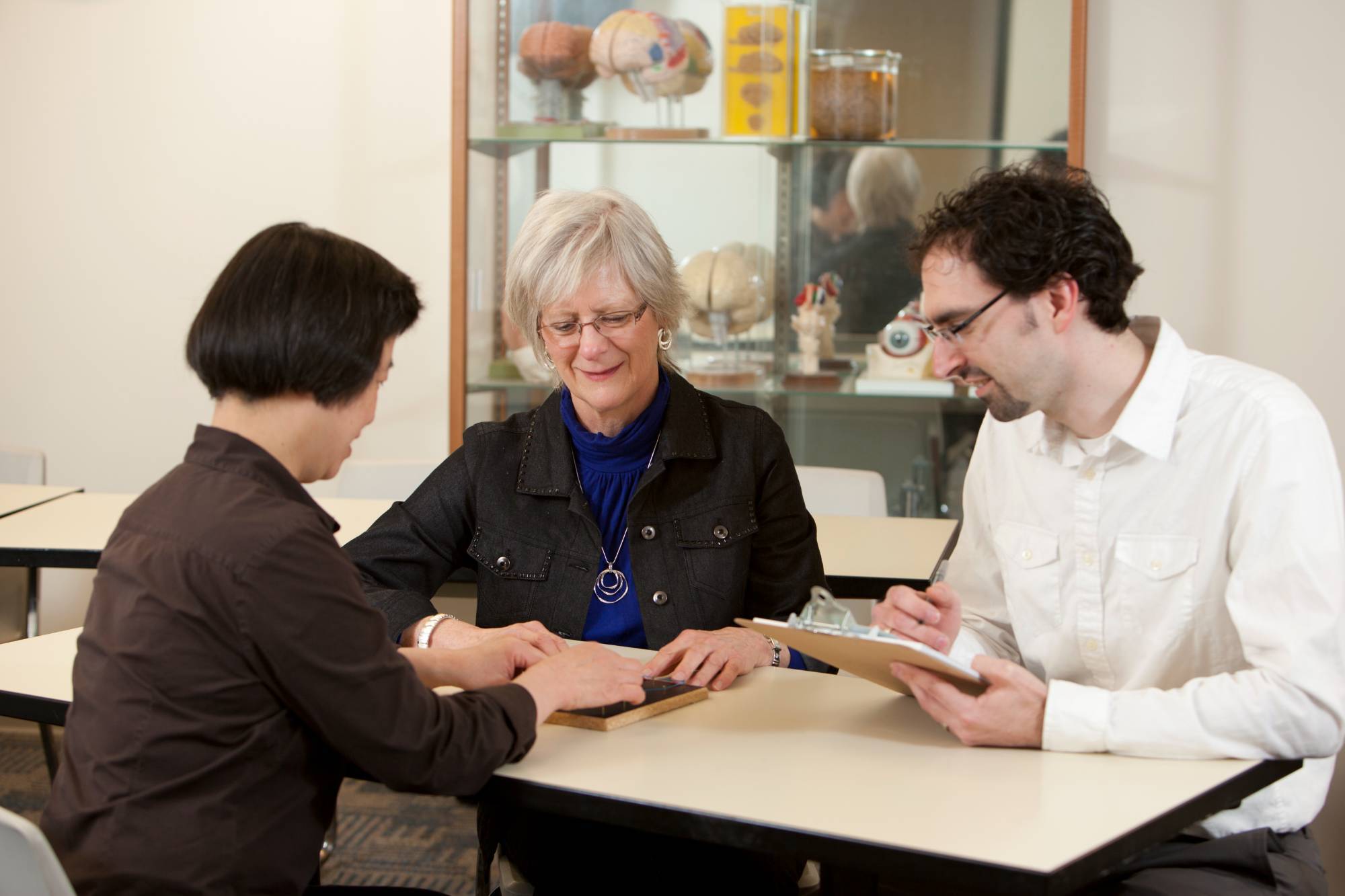 Researchers working with an older adult participant